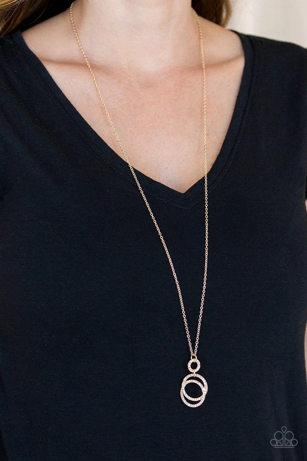 Paparazzi Accessories Timeless Trio - Gold Encrusted in radiant peach rhinestones, three gold hoops interlock at the bottom of an elongated gold chain for an elegant look. Features an adjustable clasp closure. Sold as one individual necklace. Includes one