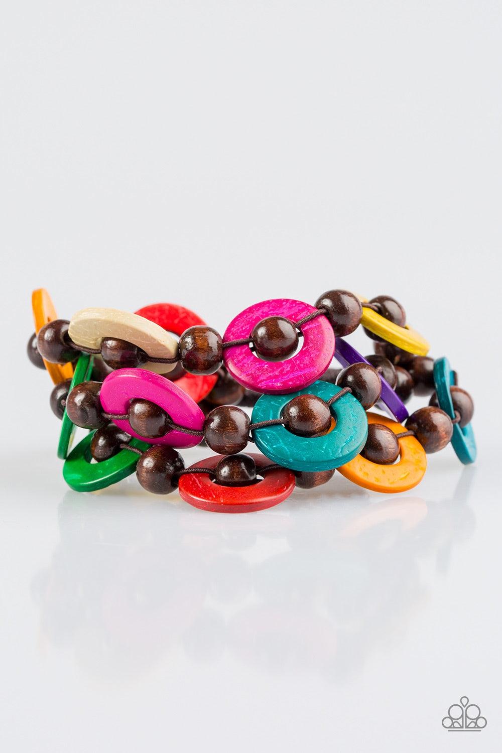 Paparazzi Accessories Cancun Catch - Multi Brushed in vivacious multicolored finishes, wooden rings and brown beads are knotted in place along three stretchy strands, creating summery layers around the wrist. Features a button loop closure. Jewelry