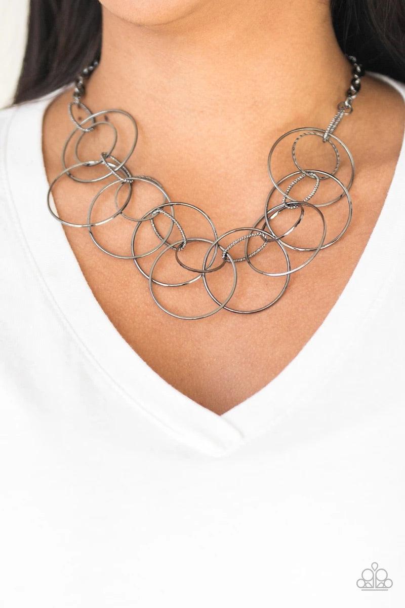 Paparazzi Accessories Circa De Couture - Black Textured gunmetal links connect to a collection of glistening gunmetal hoops below the collar, creating a statement-making fringe. Features an adjustable clasp closure. Sold as one individual necklace. Includ