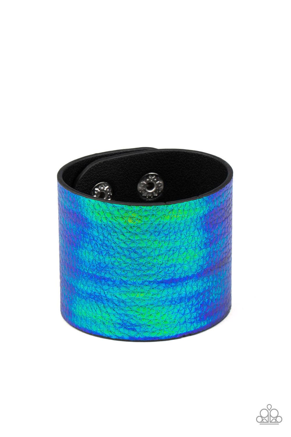Paparazzi Accessories Cosmo Cruise - Blue Featuring an iridescent crocodile print, a shimmery blue and green tie-dye leather band wraps around the wrist for an out-of-this-world fashion. Features an adjustable snap closure. Sold as one individual bracelet