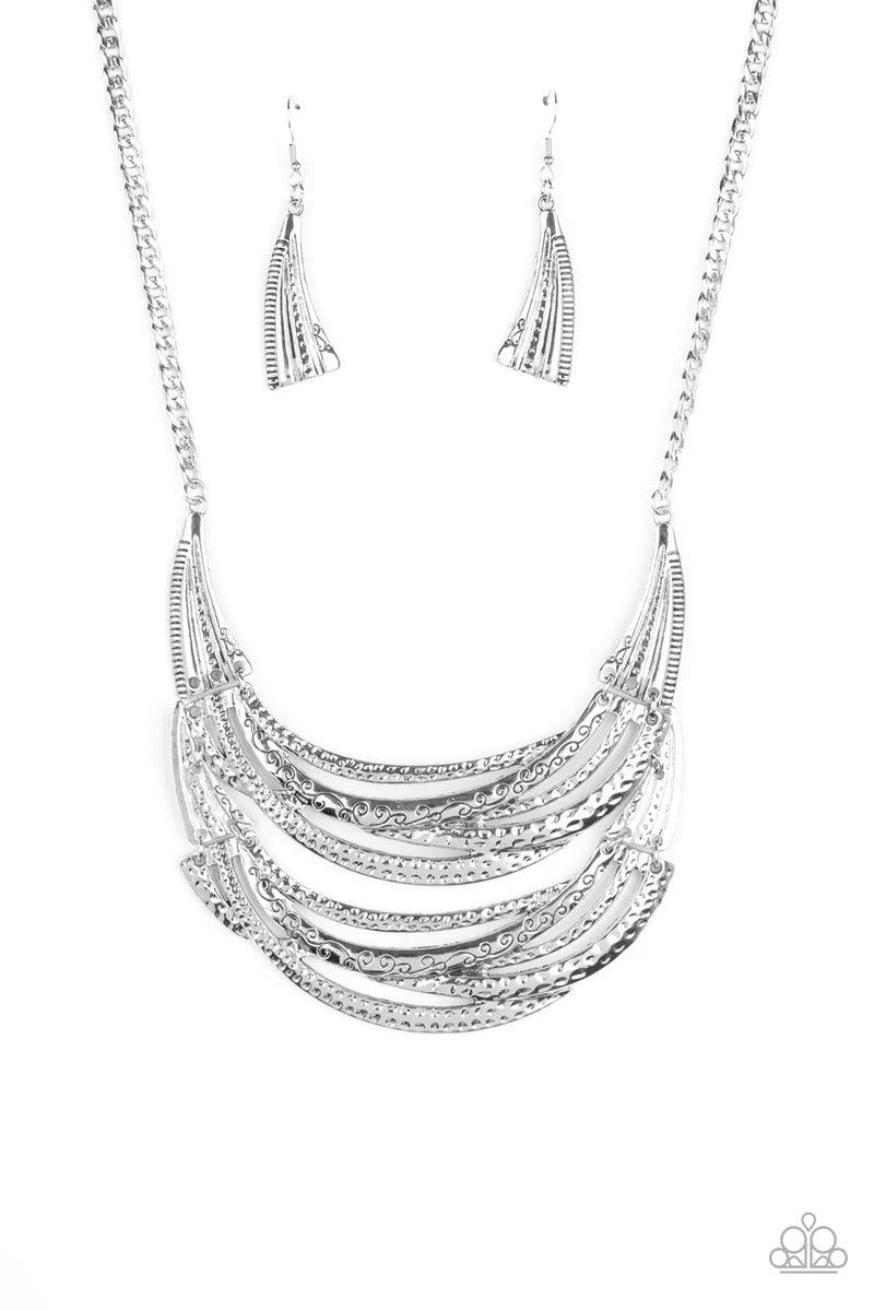 Paparazzi Accessories Read Between The Vines - Silver Stamped in sections of vine-like patterns, abstract hammered plates and overlapping silver bars link into an exaggerated pendant below the collar for a statement-making look. Features an adjustable cla