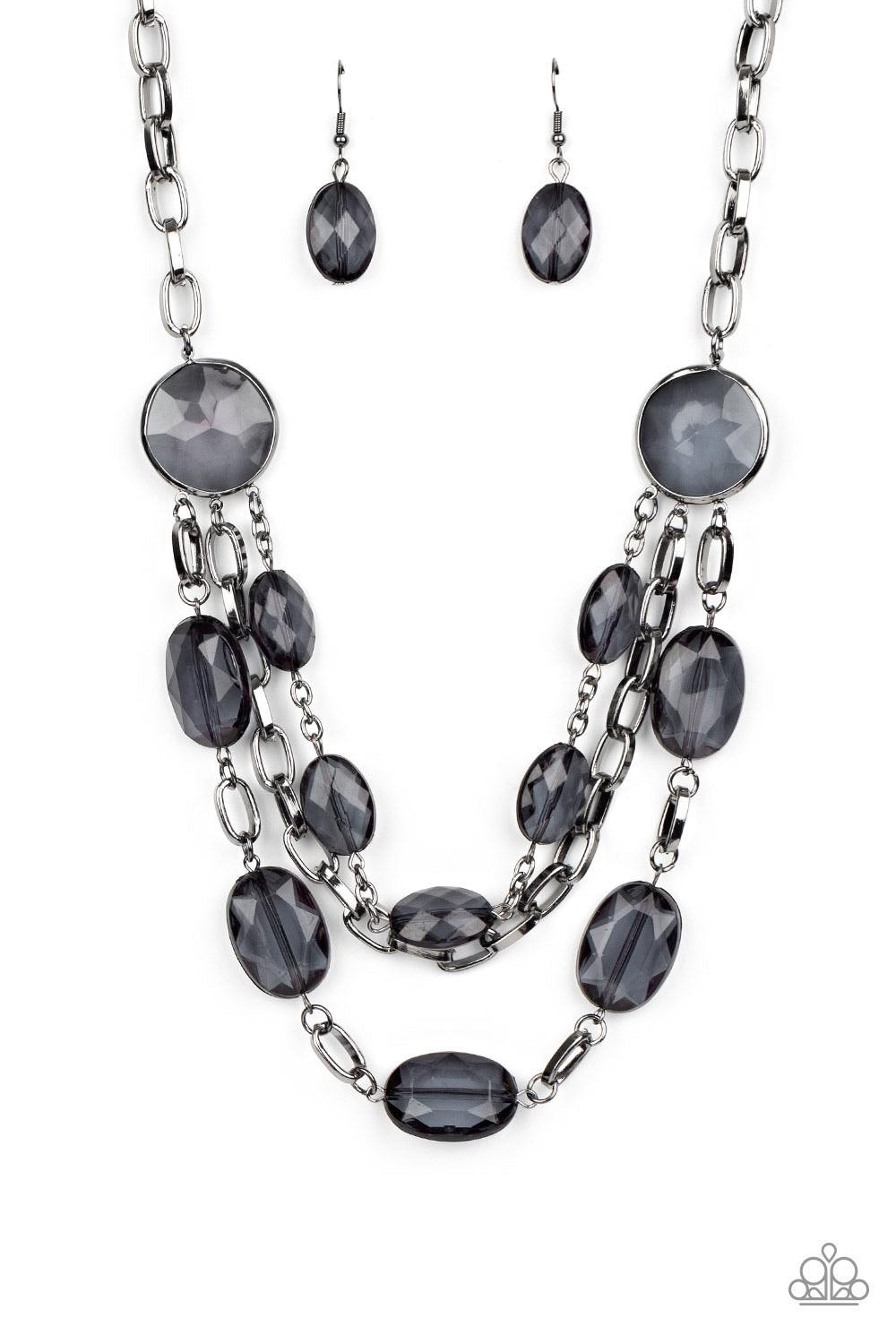 Paparazzi Accessories I Need A GLOW-Cation - Black Strung between two matching black gem-like fittings, two glittery rows of black oval gems flank a strand of bold gunmetal chain below the collar for a flawlessly layered look. Features an adjustable clasp