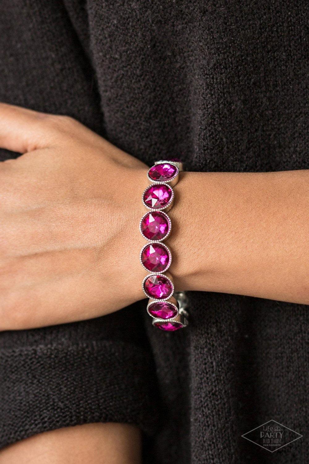 Paparazzi Accessories Number One Knockout - Pink Faceted pink gems are pressed into sleek silver frames. The glittery frames are threaded along elastic stretchy bands, creating a glamorous look around the wrist. Sold as one individual bracelet. Jewelry
