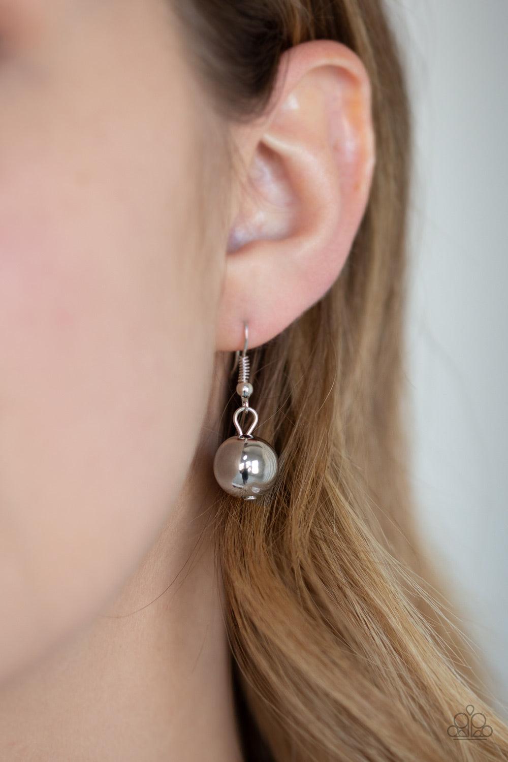 Paparazzi Accessories Colorfully Confident - Purple A collection of classic silver beads, ornate silver accents, and metallic purple faux rock beads are threaded along an invisible wire below the collar for a statement-making finish. Features an adjustabl