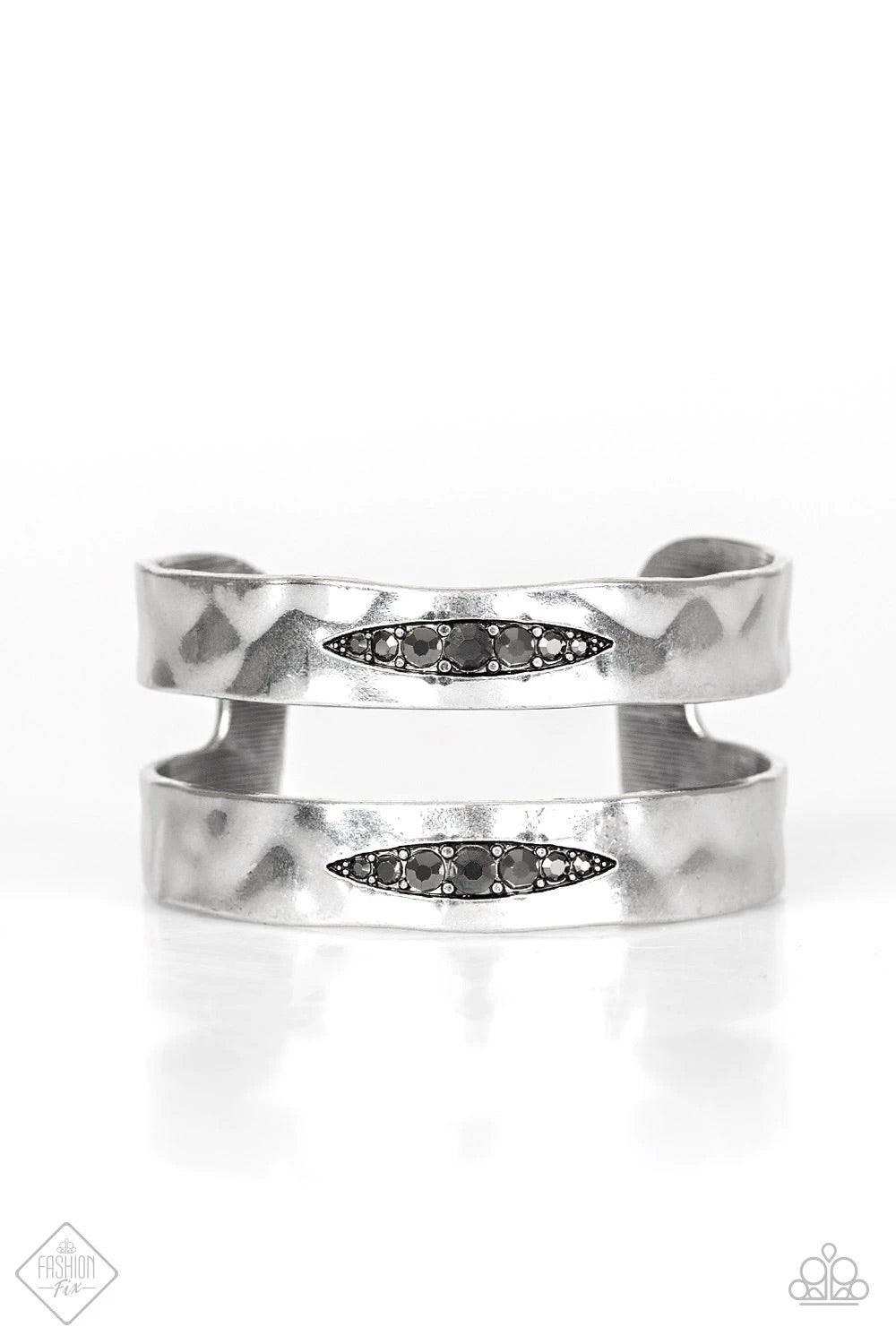 Paparazzi Accessories In HAUTE Pursuit ~Black Hammered silver bars arc across the wrist, combining into a bold cuff. A marquise-shaped cutout is filled with glittery hematite rhinestones along the centers of the cuff in an edgy finish. Sold as one individ