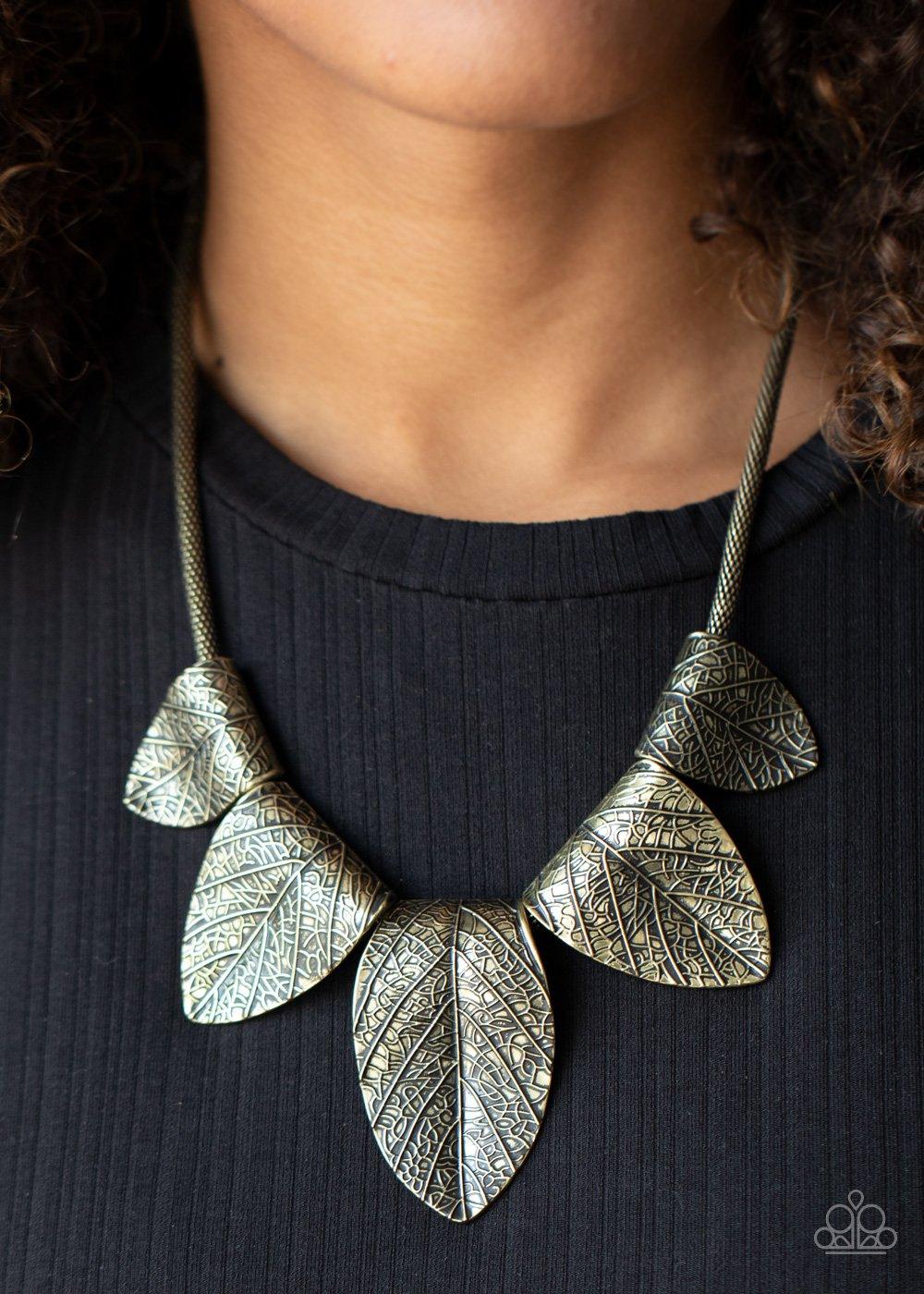 Paparazzi Accessories Garden Gatherer - Brass Embossed in life-like detail, shimmery brass leaf frames delicately fold around a rounded brass box chain. Gradually increasing in size, the dramatic frames fan out below the collar for a statement making look