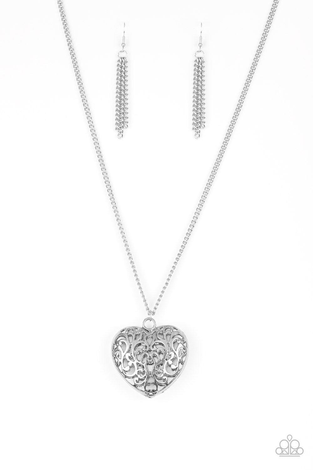 Paparazzi Accessories Victorian Valentine ~Silver Featuring vine-like filigree, a dramatic locket-like heart swings from the bottom of a lengthened silver chain for a vintage inspired look. Features an adjustable clasp closure.