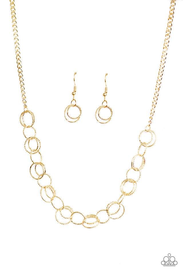 Paparazzi Accessories One Ring LEADS To Another - Gold Delicately etched in radiant textures, dainty gold rings join below the collar in a dizzying fashion. Features an adjustable clasp closure. Jewelry